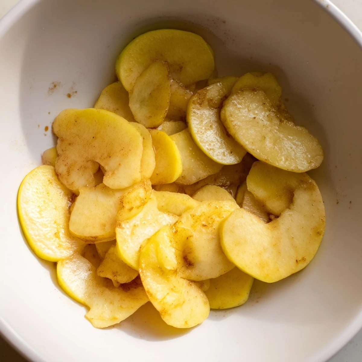 Warm, aromatic baked apple slices glistening with a sweet sauce; perfect for a cozy treat.