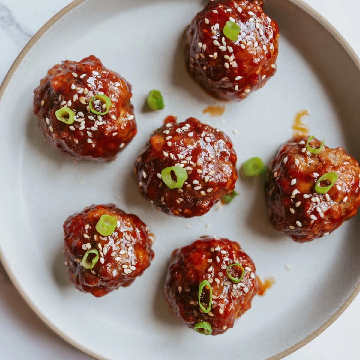 Tender Spicy Sriracha Honey Meatballs, glistening with a vibrant glaze, are perfect for appetizer enjoyment.