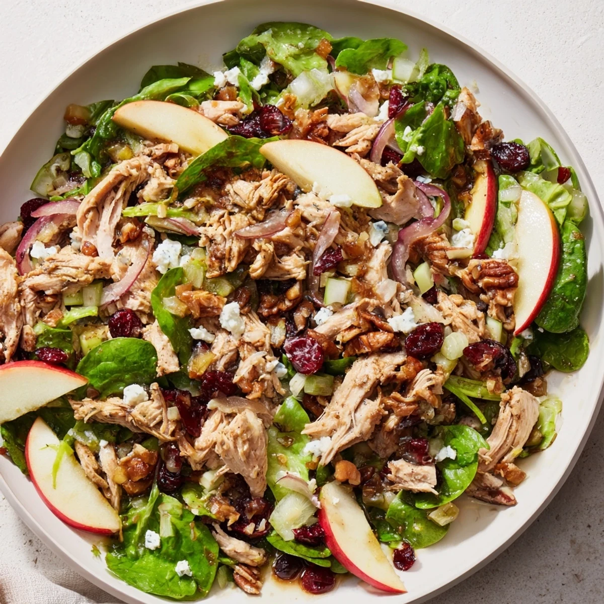 Freshly tossed Chicken and Apple Winter Salad: Apples, chicken, and pecans look inviting for a healthy meal.