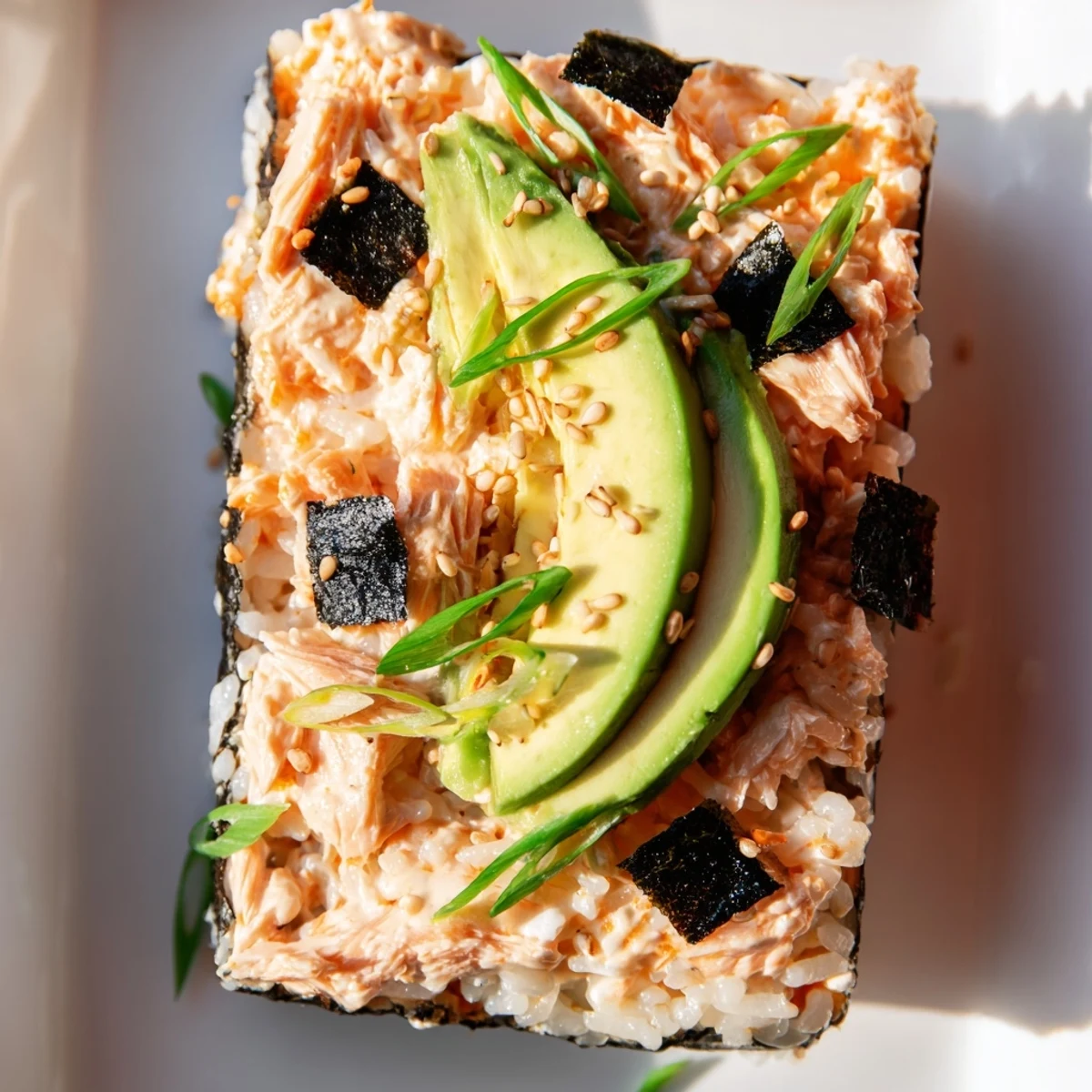 Warm, baked Sushi Bake Casserole, showcasing creamy salmon, avocado, and nori, ready to be served.