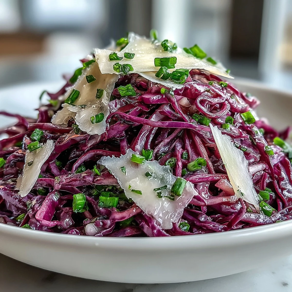Crunchy vegetarian Red Cabbage Coleslaw With Apple and Parmesan, topped with fresh parsley and served in a rustic ceramic bowl.