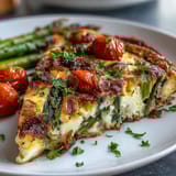 Spring Veggie Frittata with Asparagus and Goat Cheese, a fluffy baked egg dish loaded with seasonal vegetables and creamy cheese.