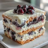 Showcasing a slice of chilled Lemon Blueberry Icebox Cake with vibrant berries and creamy filling.