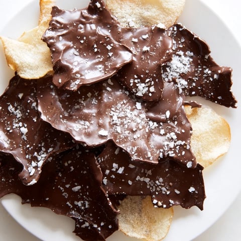A close-up of delicious Chocolate Potato Chip Bark glistening with sea salt, ready to enjoy.