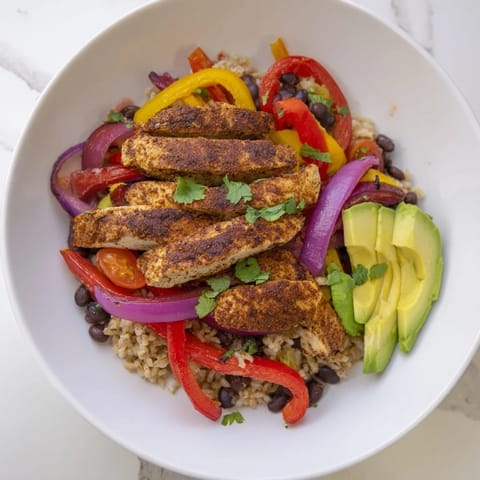 Make-Ahead Chicken Fajita Meal Prep Bowls: sizzling chicken, peppers, onions atop rice, perfect for easy, healthy lunches.