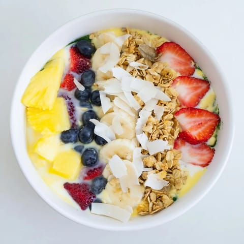 Creamy, blended Breakfast Smoothie Packs with a swirl of fresh berries and crunchy granola to enjoy.