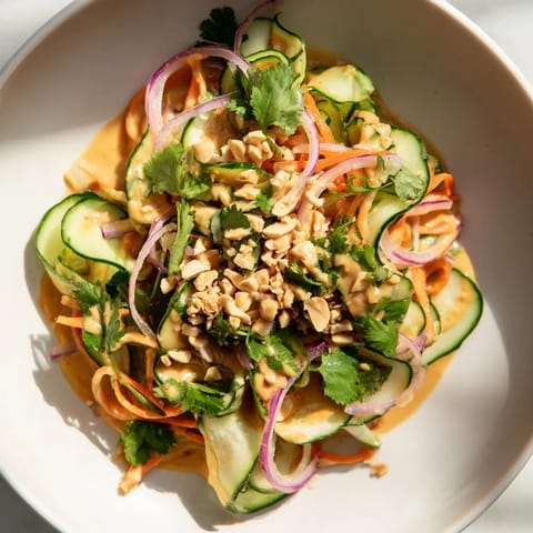 Crisp veggies coated in a flavorful peanut dressing, this Thai-Style Peanut Cucumber Salad is perfect!
