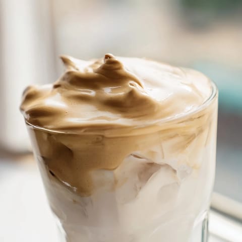 Whisked instant coffee creates a fluffy, caramel-hued topping for this Korean-inspired Dalgona coffee drink.  