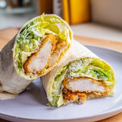 Freshly fried chicken strips wrapped in a soft tortilla with Caesar dressing and grated Parmesan.  