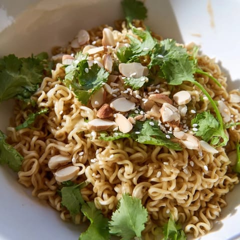 A vibrant salad of tender rotisserie chicken, fresh scallions, and crunchy almonds, ideal for a quick lunch or potluck side.  