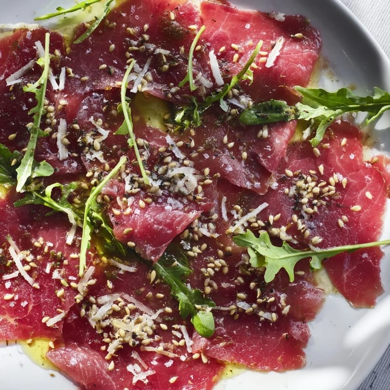 Savory Origami Fold Beef Appetizer, ready to be served, shows off precise geometric folds, drizzled.