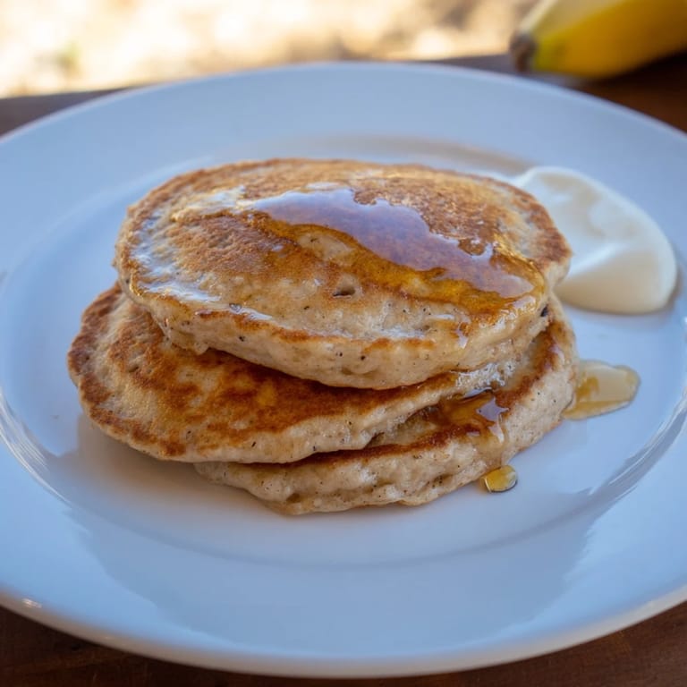 Close-up of freshly cooked Protein Banana Pancakes, offering a hint of the sweet, comforting aroma.