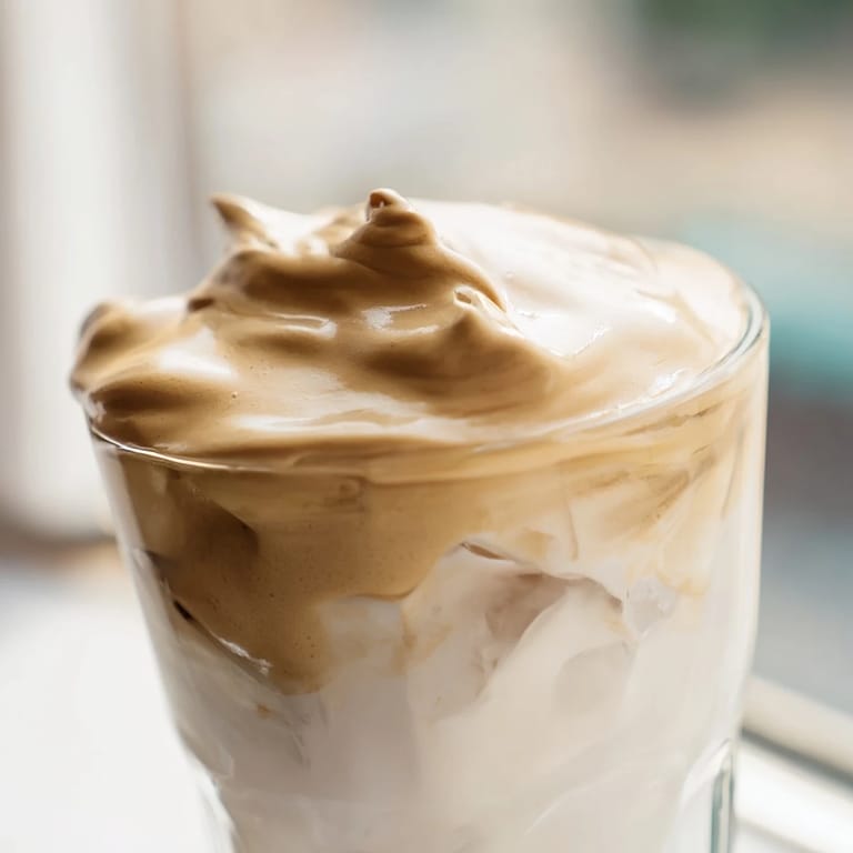 Whisked instant coffee creates a fluffy, caramel-hued topping for this Korean-inspired Dalgona coffee drink.  