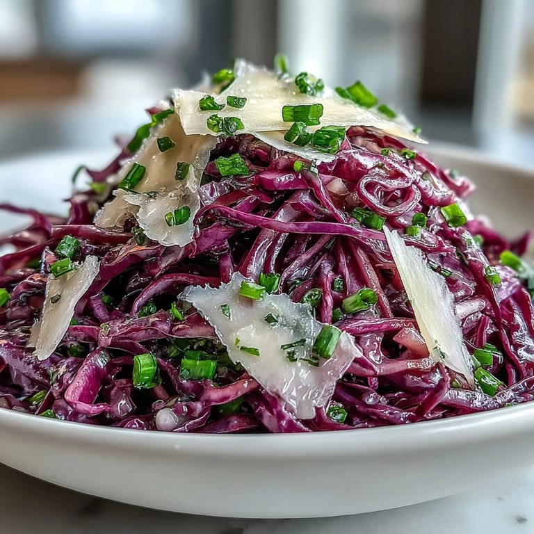 Crunchy vegetarian Red Cabbage Coleslaw With Apple and Parmesan, topped with fresh parsley and served in a rustic ceramic bowl.