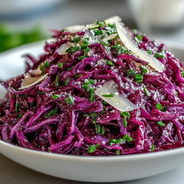 Quick and easy Red Cabbage Coleslaw With Apple and Parmesan, featuring vibrant purple and green vegetables mixed with savory cheese.