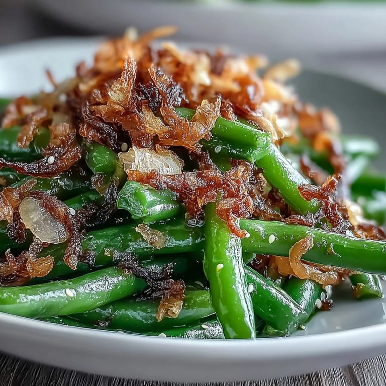 Tender green beans tossed in aromatic garlic and sesame, finished with crunchy crispy onions.